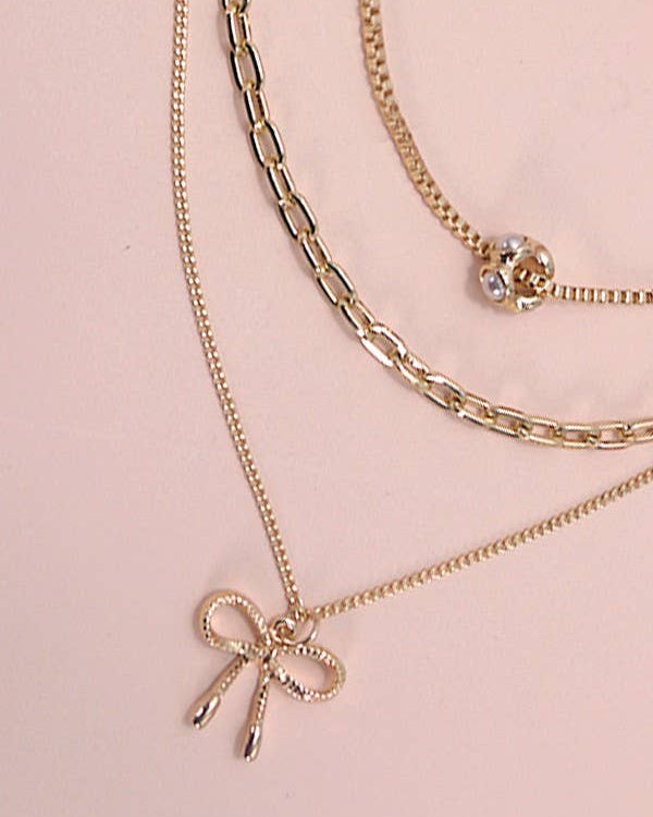 Pearl Bow Charm Necklace | 80N605 Gold Gold necklace JOSSLYN by wall to wall- Tilden Co.